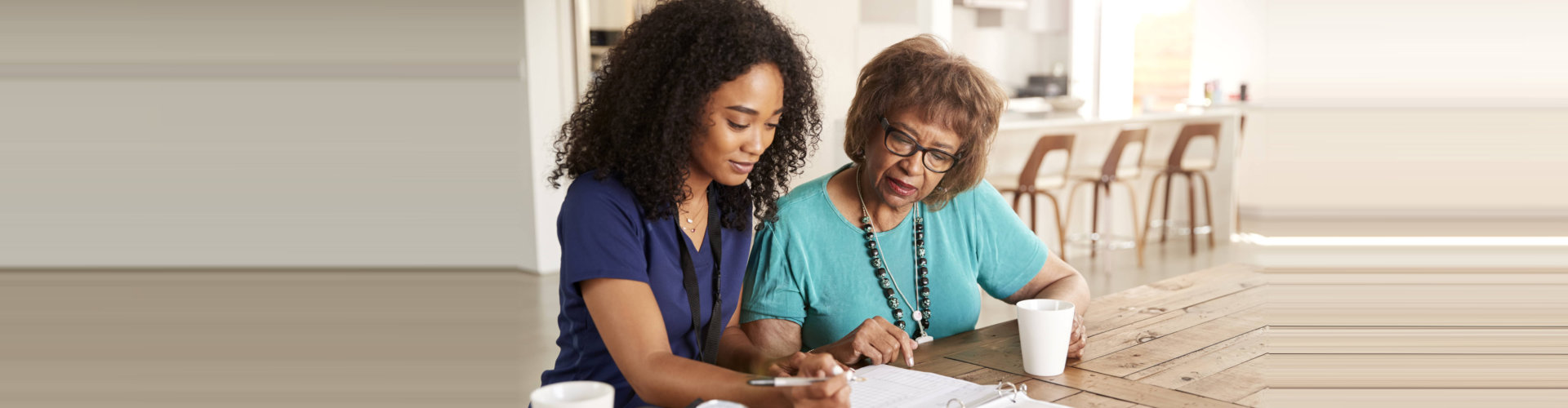 caregiver assisting senior woman answering the form